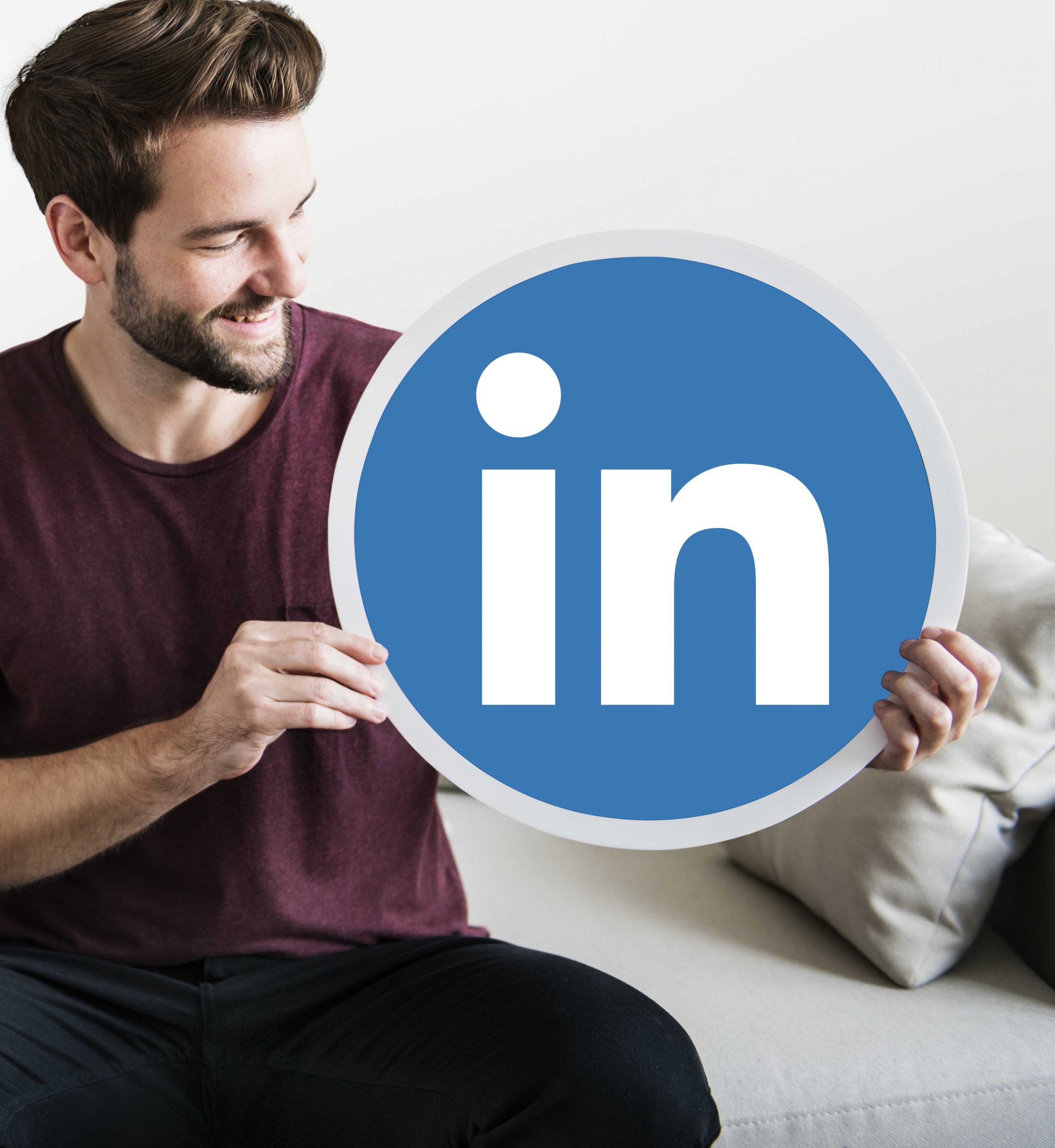 Person holding a Linkedin icon